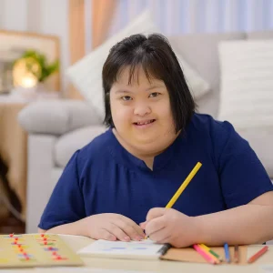Disabled woman drawing in notepad